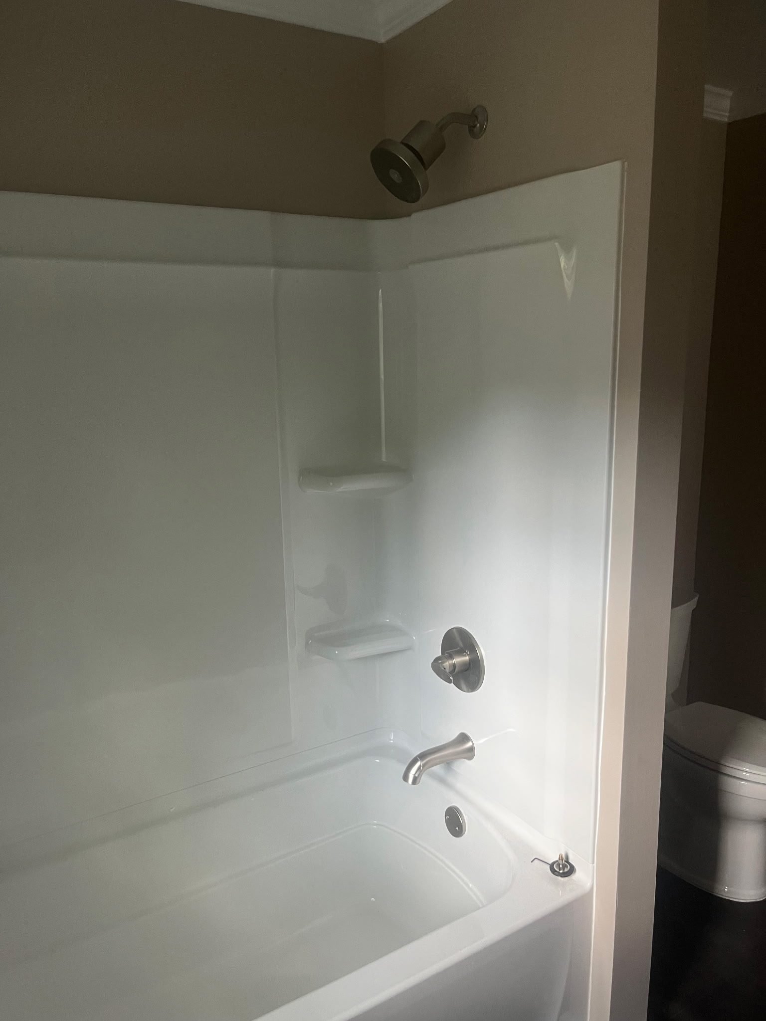 Tub and shower with brushed nickel fixtures installed during finish plumbing in Yadkinville, NC