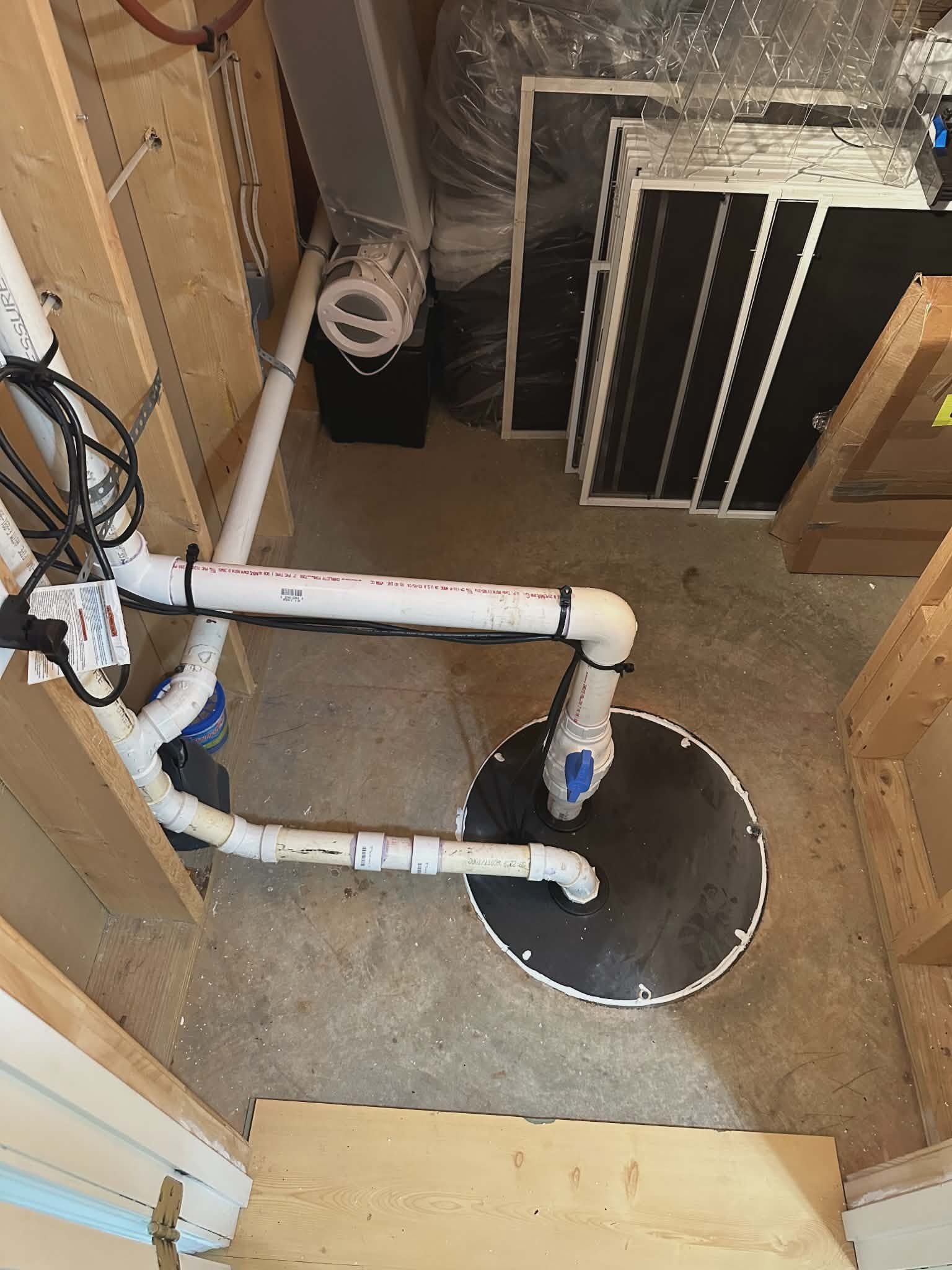 Tankless water heater mounted on exterior wall siding next to an outdoor AC condenser.