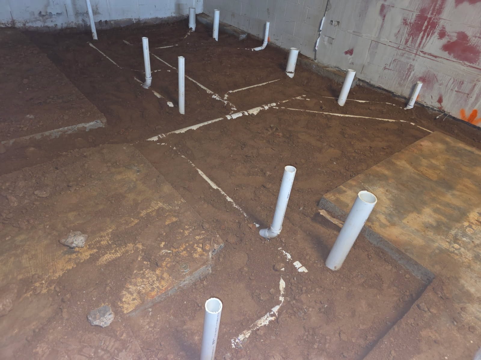 Overhead view of PVC stub-up and vent piping layout during new construction rough-in