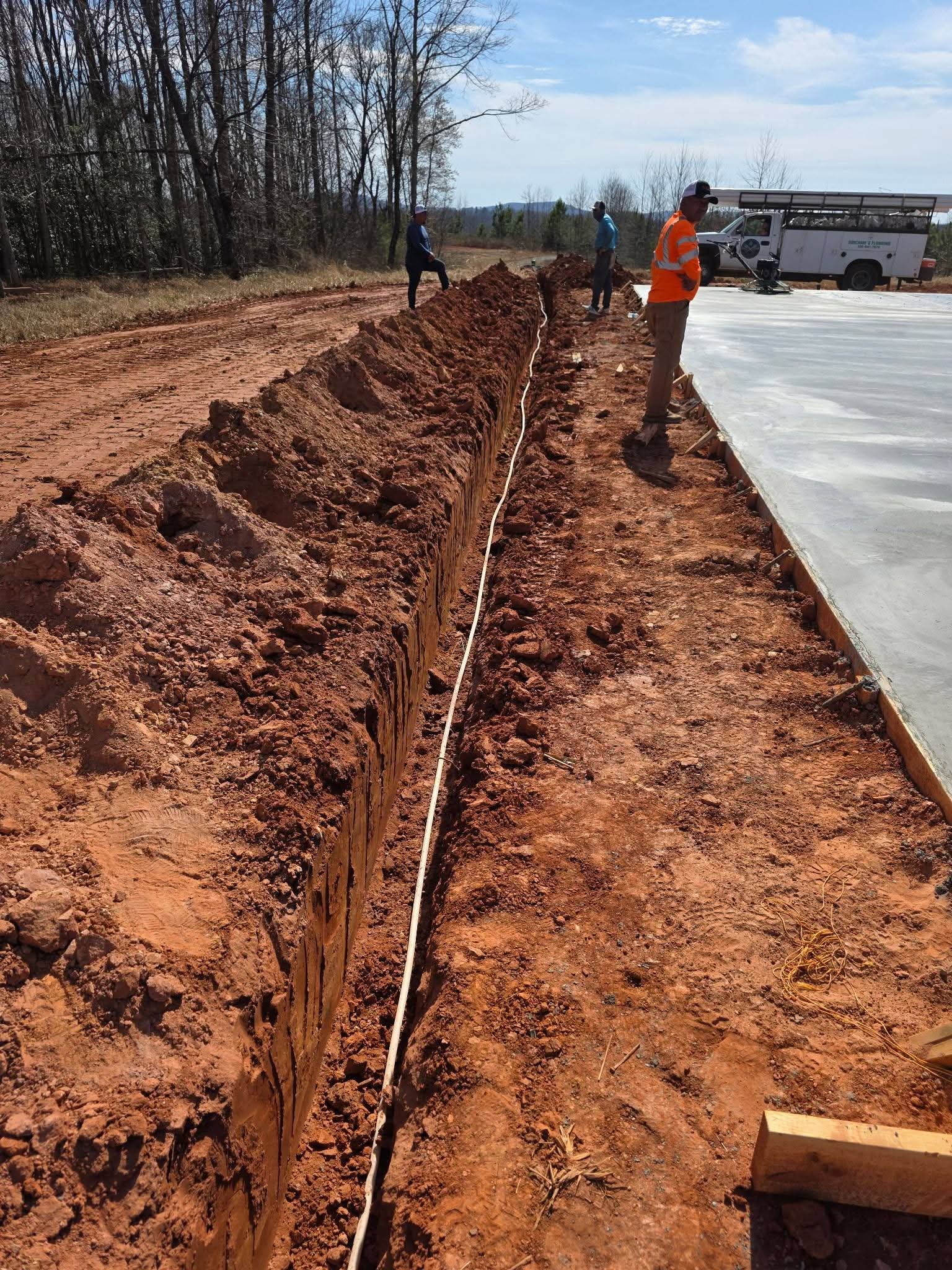 Close-up of trench floor and pipeline preparation for underground plumbing at a residential new-build project.