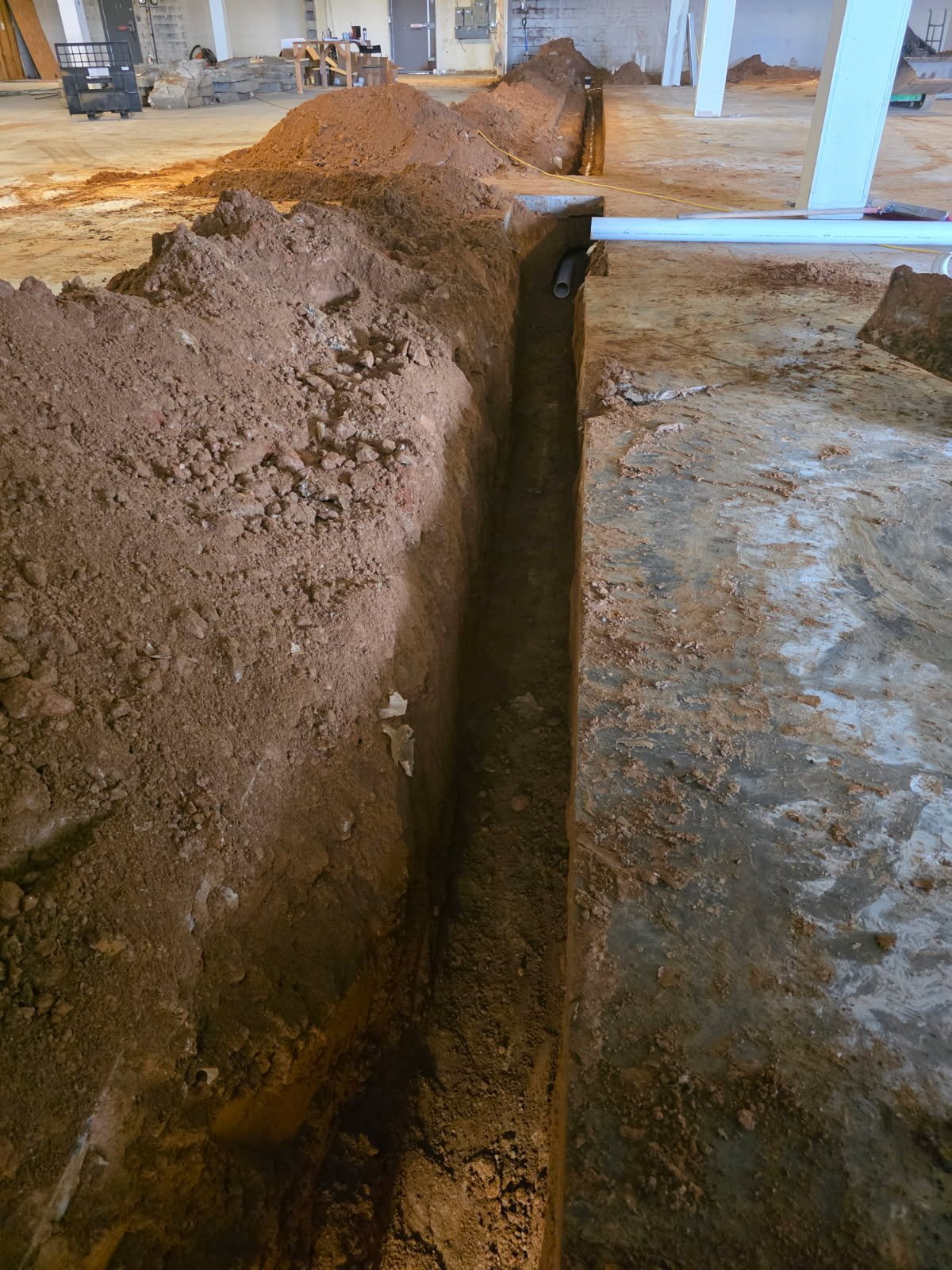 Additional interior pipeline preparation showing routing for multi-stall restrooms and high-volume water use.